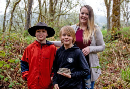 Oregon boy and family posing with mammoth tooth