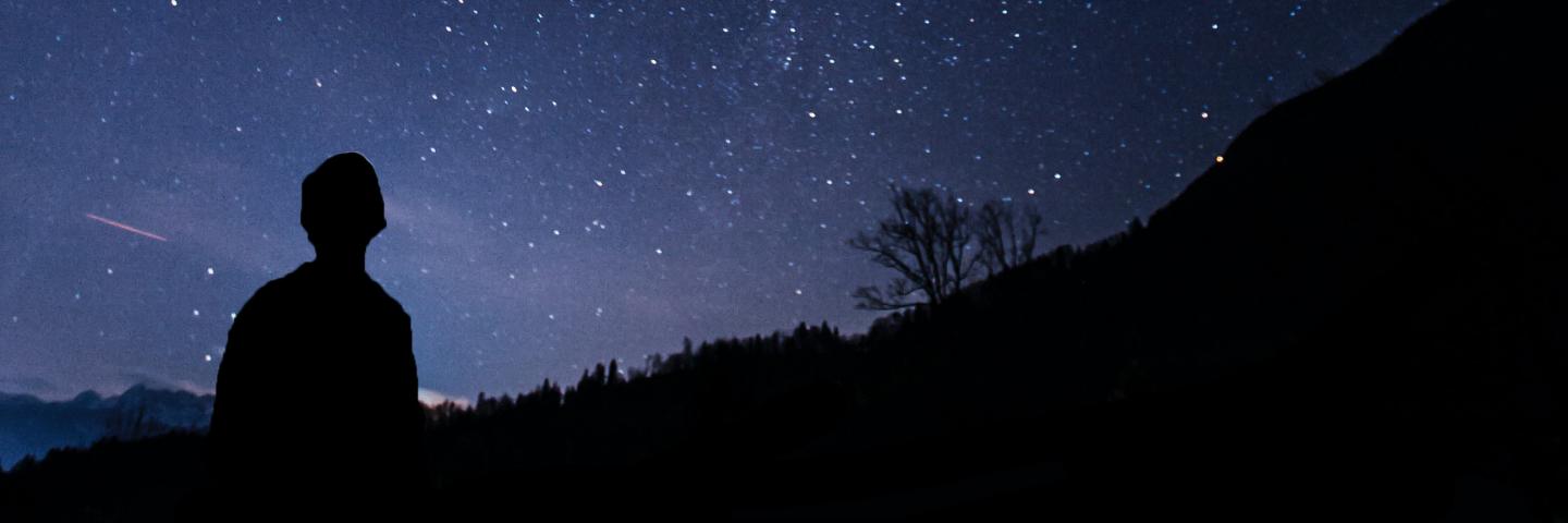 Silhouette of a child looking up at the stars