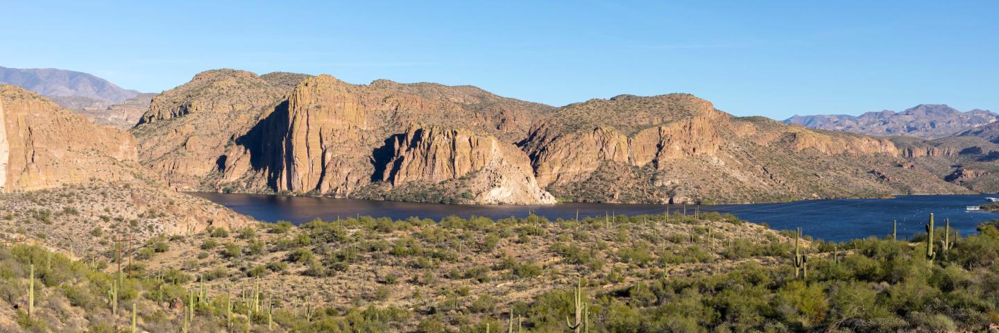 A wide shot of Canyon Lake in Arizona with mesas rising behind it
