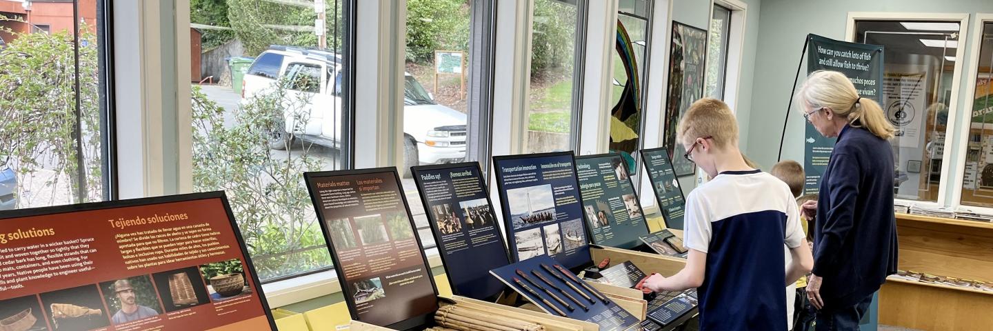 Family using Native Innovation exhibit at a library