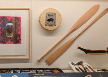 An exhibit case with art by Shirod Younker