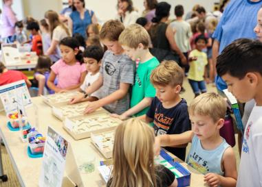 A group of children play a game in a library
