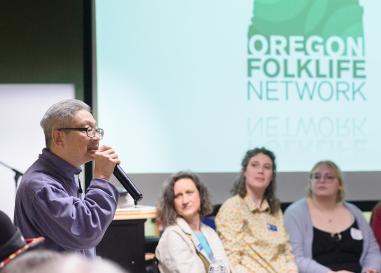 David Leung speaks to a group of people