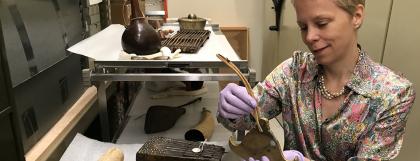 Composer Augusta Reed Thomas studying objects from the museum's musical instruments collection