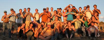 Group of field school students throwing the "O" hand sign