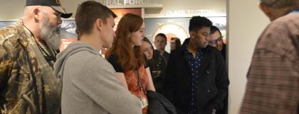 Students touring the museum's Paisley Caves exhibit