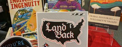 A table of Indigenous-created books, stickers, and prints.