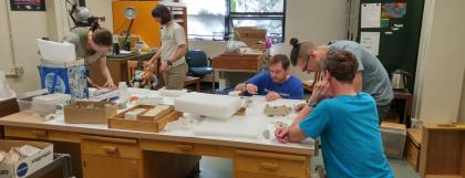 Paleontology students working at a lab table