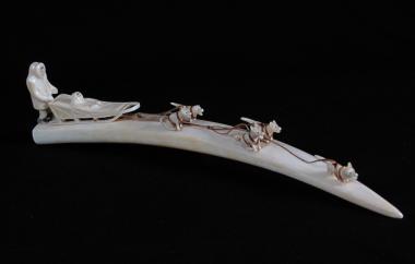 Ivory carving of musher and dogs