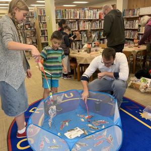A family fishes in a library