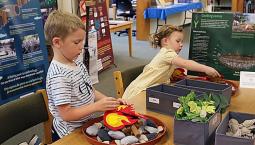 Kids making model earth ovens