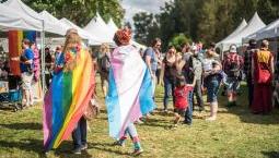 People wearing pride flags at festival